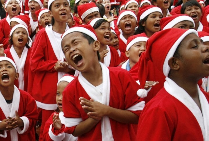 Indonesian children dressed in Santa Claus costumes sing along to Christmas carols in Jakarta, Indonesia. ©Reuters/Supri