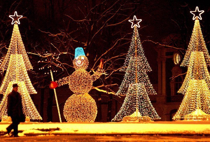 A man walks past illuminated installations in the shape of a snowman and Christmas trees in the centre of St. Petersburg, Russia. ©Reuters/Alexander Demianchuk