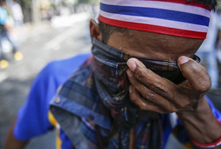 A protester covers his face with a wet cloth trying to protect his eyes from the tear gas. ©Reuters