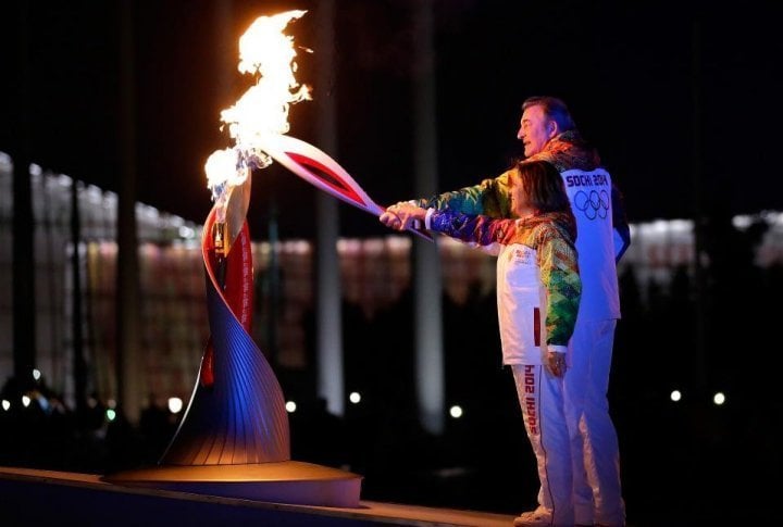 Russian torchbearers Irina Rodnina (L) and Vladislav Tretyak light the Olympic cauldron at the opening ceremony of the 2014 Winter Olympics on February 7, 2014, in Sochi. ©sochi2014.com