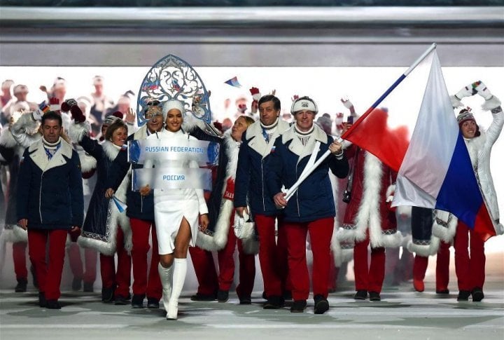 Russian model Irina Shayk (C) and flag bearer, bobsledder Alexander Zubkovleads, lead their national delegation. ©sochi2014.com