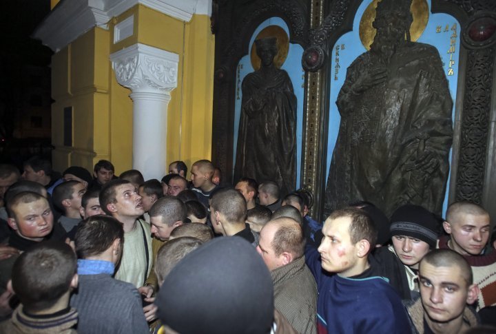 The Interior Ministry officers captured by anti-government protestors during clashes with riot police in Kiev. ©Reuters 