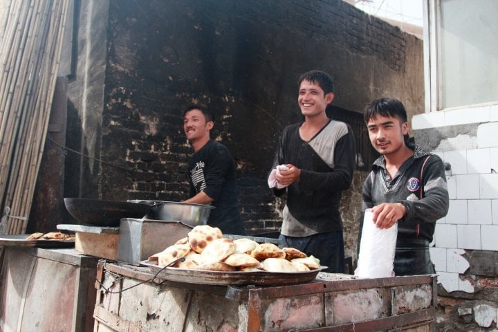 Preparation of traditional food in tandyr owen. ©Vladimir Prokopenko