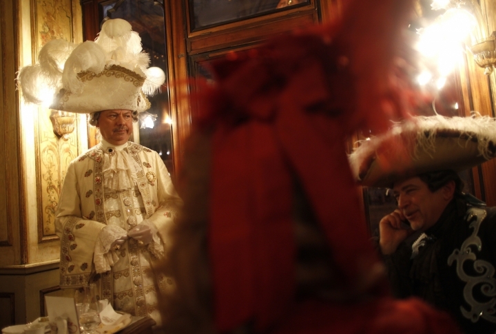 Masked revellers stand inside Caffe' Florian coffee shop in Saint Mark's Square during the Venetian Carnival in Venice . ©REUTERS/Tony Gentile