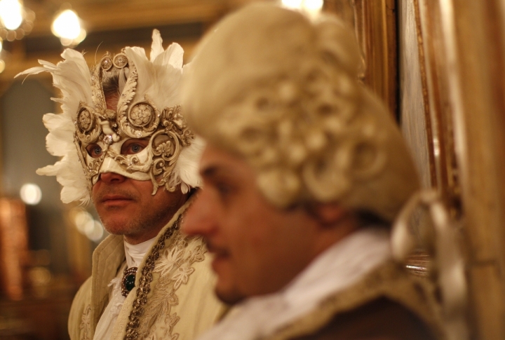 Masked revellers stand inside Caffe' Florian coffee shop in Saint Mark's Square during the Venetian Carnival in Venice . ©REUTERS/Tony Gentile