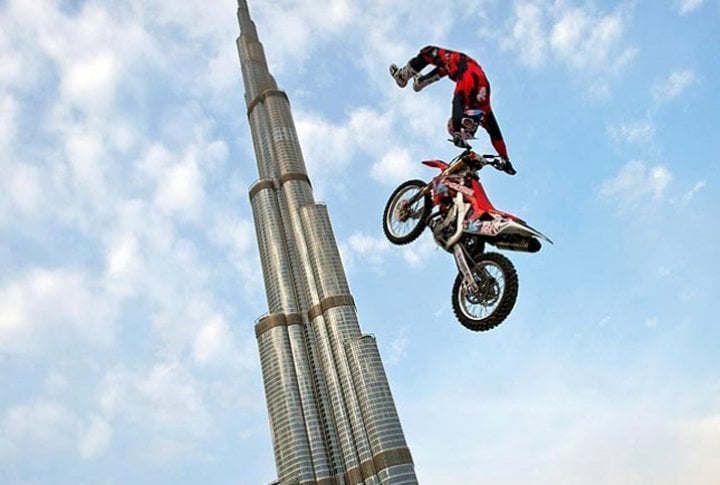 Motorcross biker performs a show jump in front of the world's tallest building, Burj al-Khalifa in Dubai. Photo courtesy of SI.com