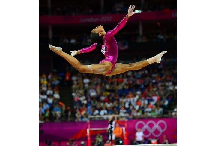 Gabby Douglas became the third straight U.S. woman to win the all-around and the first to win that title and a team gold at the same Olympics. Photo courtesy of SI.com