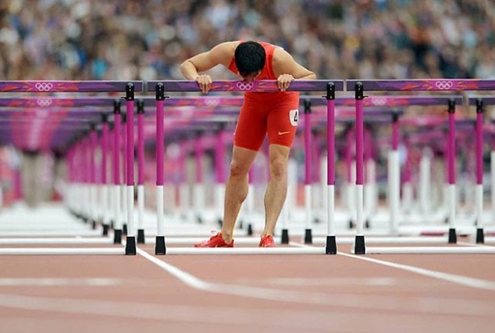 Chinese Olympian Liu Xiang reacts after crashing during the 110m hurdles heats in London. Photo courtesy of SI.com