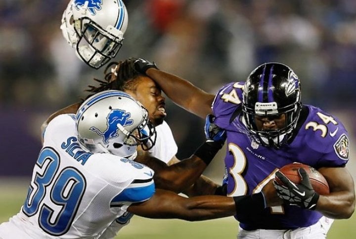 Detroit Lions' Jonte Green loses his helmet while trying to stop Baltimore's Bobby Rainey during a preseason game. Photo courtesy of SI.com