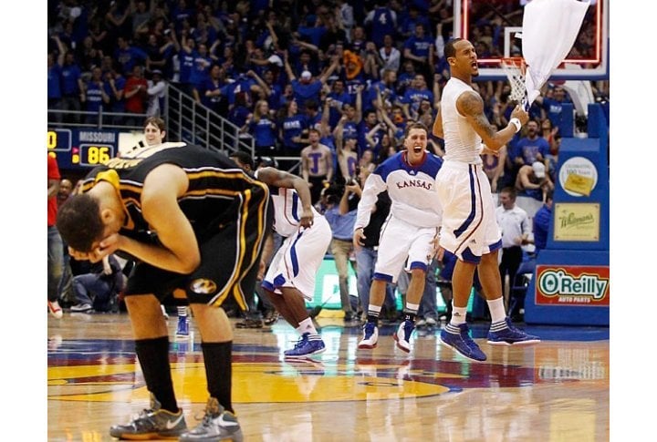 Kansas celebrates while Missouri guard Michael Dixon holds his head in despair after the Jayhawks won. Photo courtesy of SI.com