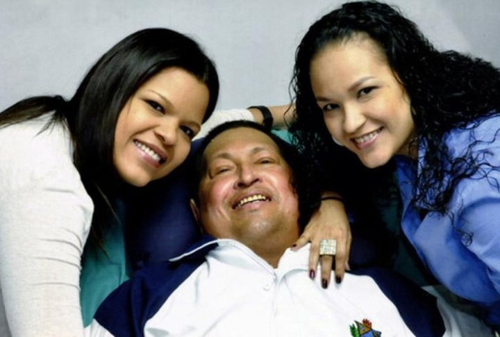 Venezuelan President Hugo Chavez smiles in between his daughters, Rosa Virginia (R) and Maria while recovering from cancer surgery in Havana. ©REUTERS/Ministry of Information/Handout