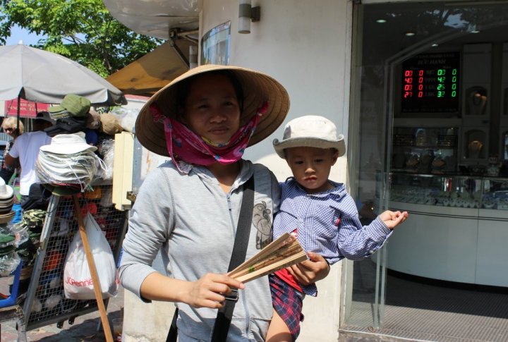 Vietnamese women tend to cover their face and body from the sun so that skin remains light. Photo by Roza Yessenkulova©