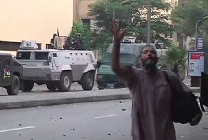 A protester gestures in front of an armoured personnel carrier as security forces break up the protest camp at al-Nahda square in Cairo August 14, 2013. ©REUTERS