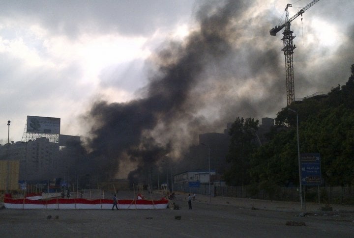 Smoke rises during clashes between riot police and members and supporters of the Muslim Brotherhood, at Rabba el Adwia Square in Cairo August 14, 2013. ©REUTERS