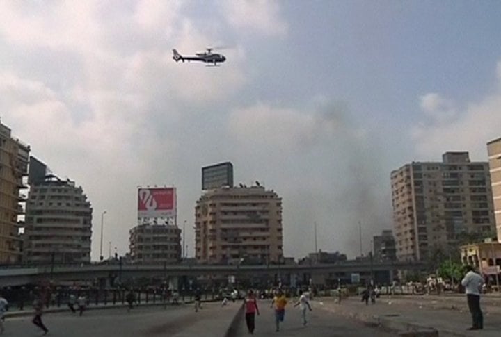 A helicopter hovers over the scene as security forces break up the protest camp at al-Nahda square in Cairo August 14, 2013. ©REUTERS