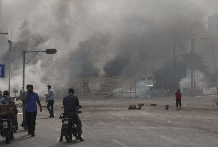 A smoke trail from a tear gas canister fired by riot police at members of the Muslim Brotherhood and supporters of deposed Egyptian President Mohamed Mursi is seen at Rabaa Adawiya square. ©REUTERS