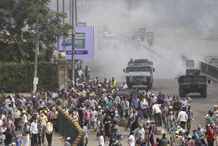 Riot police vehicles fire tear gas at members of the Muslim Brotherhood and supporters of deposed Egyptian President Mohamed Mursi. ©REUTERS