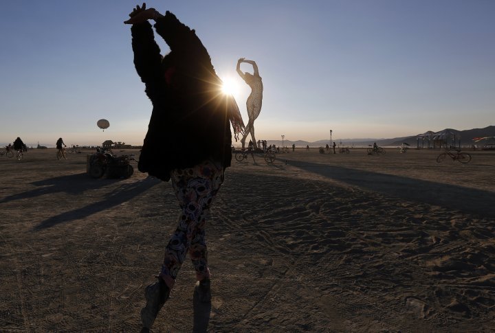 Rochelle Schieck dances by the "Truth is Beauty" sculpture created by Marco Cochrane. ©REUTERS