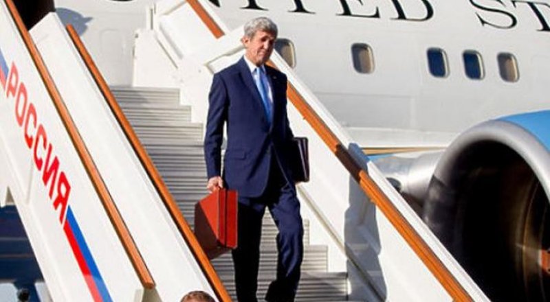 Госсекретарь США Джон Керри выходит из самолета с красным портфелем. © mk-london.co.uk