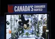 Canadian astronaut floats through chat with kids 