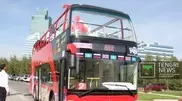 Double-decker sightseeing buses cruise Astana