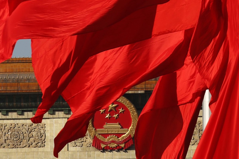 The Great Hall of the People, where the Chinese Communist Party plenum is being held, is seen behinds red flags in Tiananmen square in Beijing. ©Reuters/Kim Kyung-Hoon