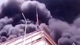 Кран жүргізушісі Алматыда жанып жатқан ғимараттың шатырынан ер адамды құтқарды