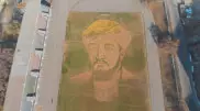 Алматыда футбол алаңында әл-Фарабидің үлкен портреті жапырақтармен салынды